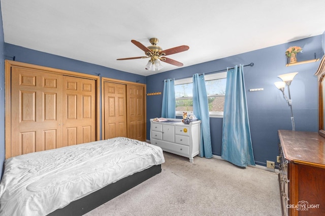 1020 Hahn Pl, West Chicago, IL 60185 - bedroom with multiple closets, light colored carpet, baseboards, and a ceiling fan