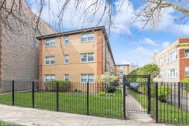 view of front of property featuring brick siding and a gate