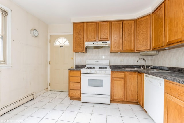 kitchen with white appliances, under cabinet range hood, a baseboard radiator, dark countertops, and decorative backsplash