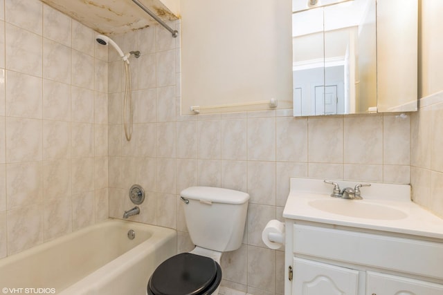 full bathroom with vanity, bathing tub / shower combination, toilet, and tile walls