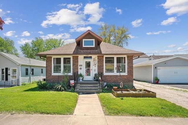 1009 W Madison St, Ottawa, IL 61350 - bungalow-style home with brick siding, a front yard, a garage, and roof with shingles