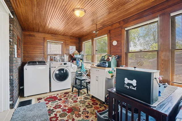 1009 W Madison St, Ottawa, IL 61350 - clothes washing area featuring washing machine and dryer, cabinet space, wooden ceiling, healthy amount of natural light, and wooden walls