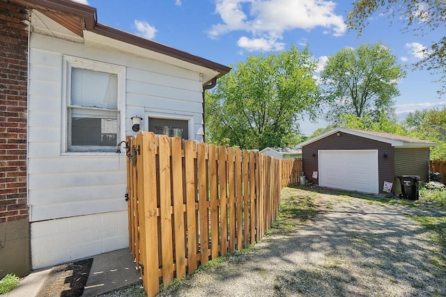 1009 W Madison St, Ottawa, IL 61350 - view of home's exterior with fence, a detached garage, an outdoor structure, and driveway