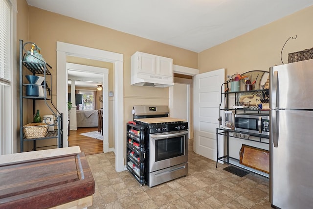 1009 W Madison St, Ottawa, IL 61350 - kitchen featuring stainless steel appliances, white cabinets, and baseboards
