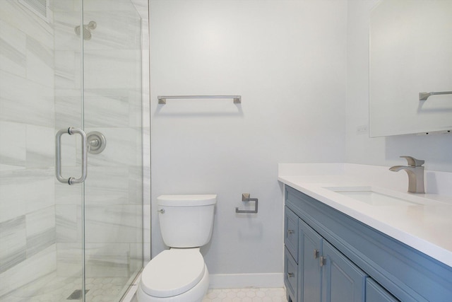 bathroom featuring a shower stall, vanity, toilet, and baseboards