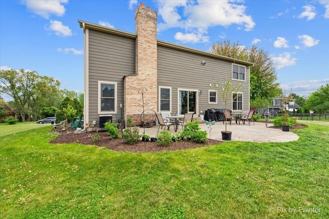 back of property with a patio and a chimney