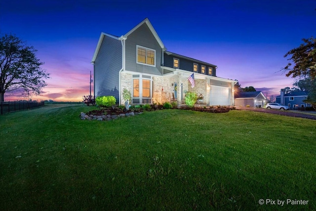 view of front of property featuring a lawn and asphalt driveway
