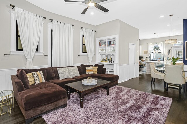 4738 S Champlain Ave, Chicago, IL 60615 - living area with dark wood finished floors, ceiling fan, a wainscoted wall, a decorative wall, and a chandelier