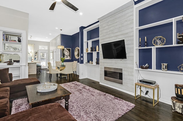 4738 S Champlain Ave, Chicago, IL 60615 - living area with a ceiling fan, wood finished floors, built in shelves, a large fireplace, and baseboards