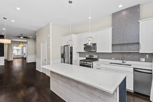 4738 S Champlain Ave, Chicago, IL 60615 - kitchen featuring stainless steel appliances, a sink, a ceiling fan, decorative backsplash, and recessed lighting