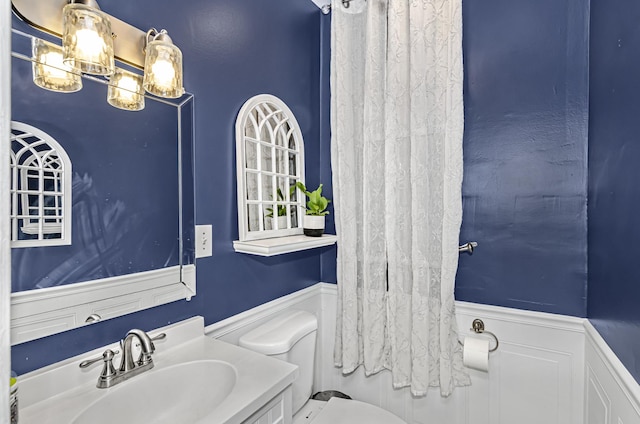 4738 S Champlain Ave, Chicago, IL 60615 - bathroom with a wainscoted wall, toilet, and vanity