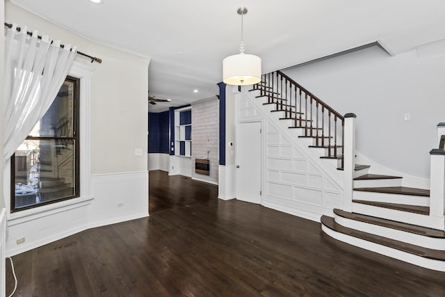 4738 S Champlain Ave, Chicago, IL 60615 - staircase with wood finished floors, ceiling fan, recessed lighting, a fireplace, and wainscoting