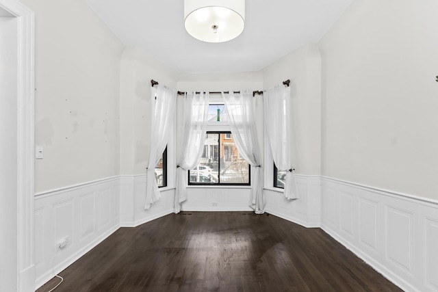 4738 S Champlain Ave, Chicago, IL 60615 - spare room with dark wood-style floors and wainscoting