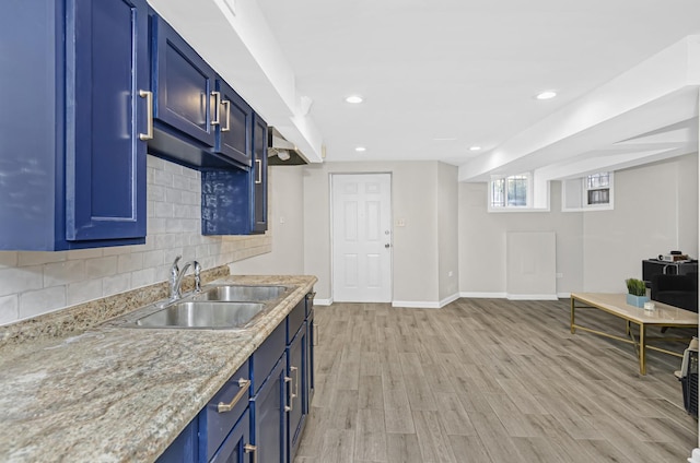 4738 S Champlain Ave, Chicago, IL 60615 - kitchen featuring a sink, blue cabinetry, baseboards, light wood-style floors, and decorative backsplash