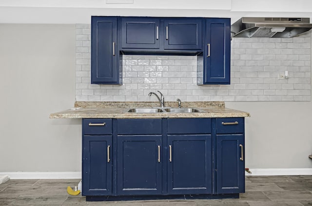 4738 S Champlain Ave, Chicago, IL 60615 - kitchen with under cabinet range hood, blue cabinetry, a sink, and dark wood-style floors