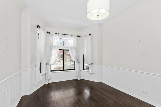 4738 S Champlain Ave, Chicago, IL 60615 - spare room with a wainscoted wall and wood finished floors
