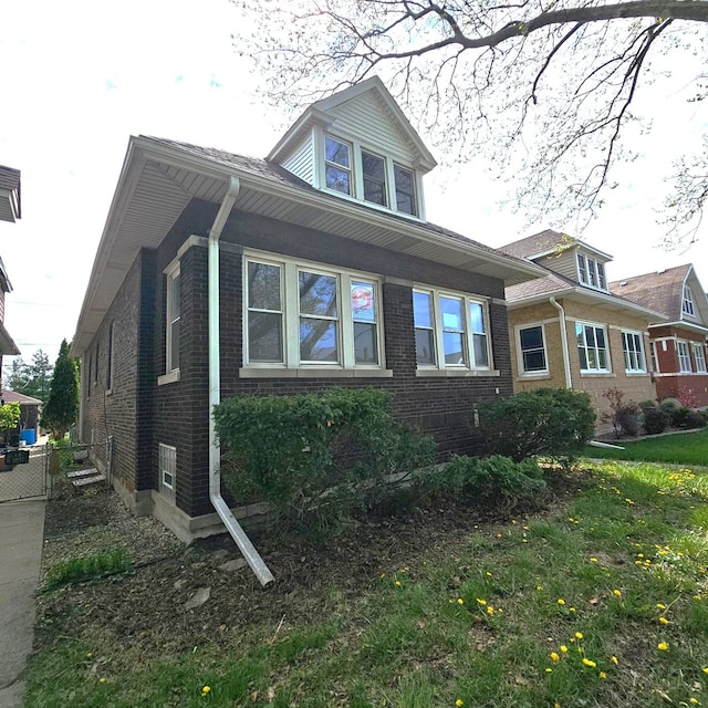 view of side of home with brick siding