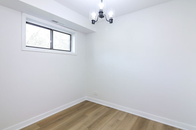 2212 Country Club Dr Unit 2, Woodridge, IL 60517 - spare room with a chandelier, wood finished floors, and baseboards