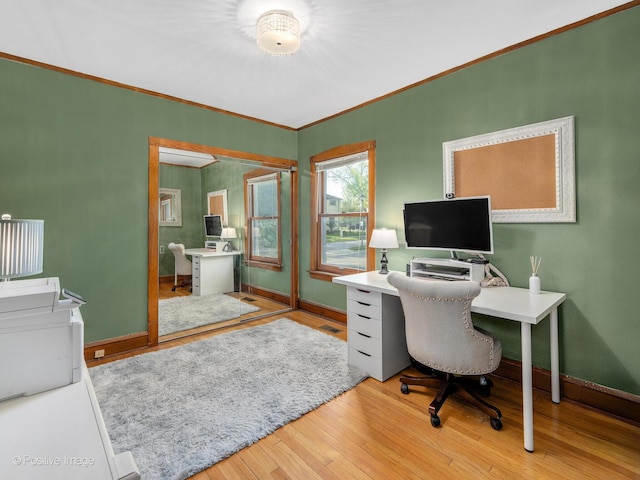 office with baseboards, wood finished floors, and crown molding