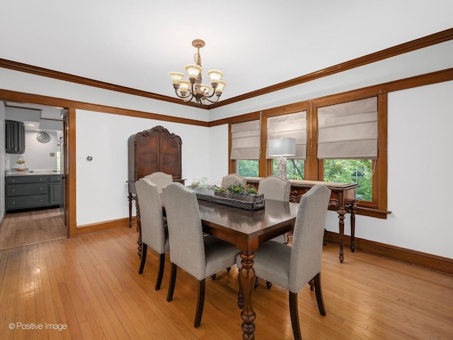 375 S Berkley Ave, Elmhurst, IL 60126 - dining space featuring a chandelier, baseboards, light wood-type flooring, and crown molding