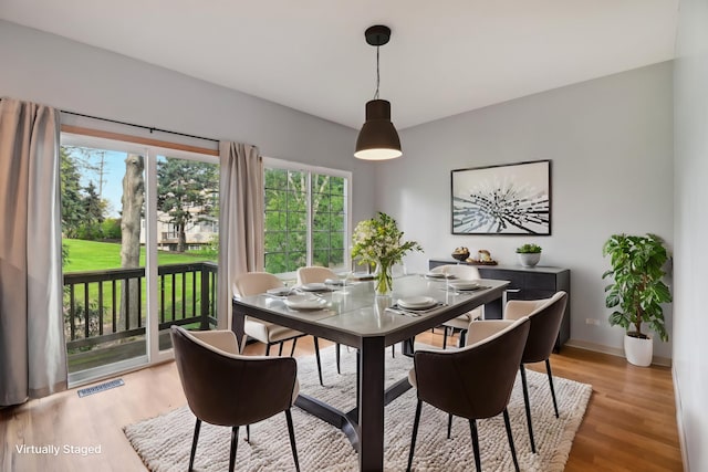 dining area with light wood finished floors and baseboards