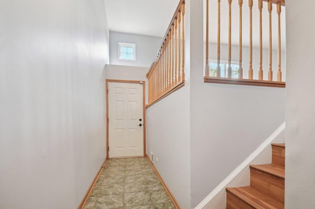 doorway featuring baseboards and stairs