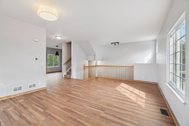 bonus room with light wood-style floors and baseboards