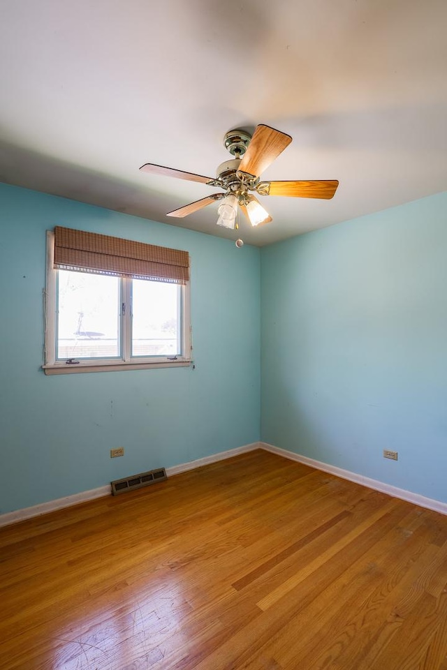 18727 Sherman St, Lansing, IL 60438 - spare room with wood finished floors, baseboards, and a ceiling fan