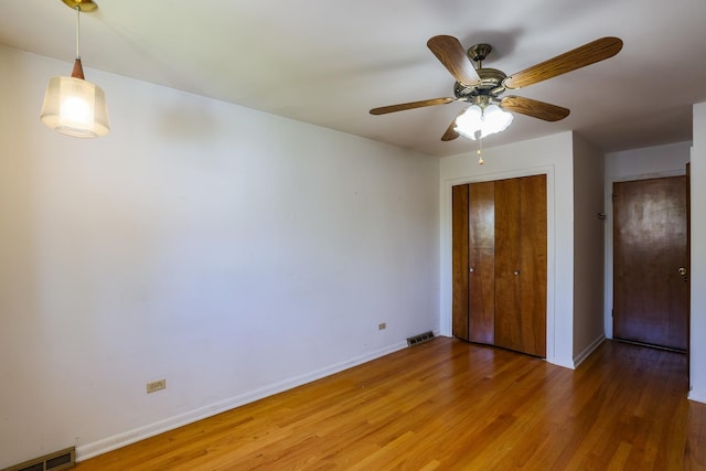 18727 Sherman St, Lansing, IL 60438 - unfurnished bedroom with light wood-style floors, baseboards, and a closet