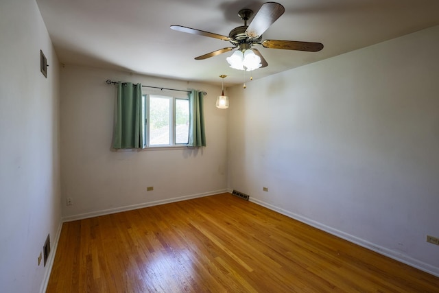 18727 Sherman St, Lansing, IL 60438 - unfurnished room with wood finished floors, ceiling fan, and baseboards
