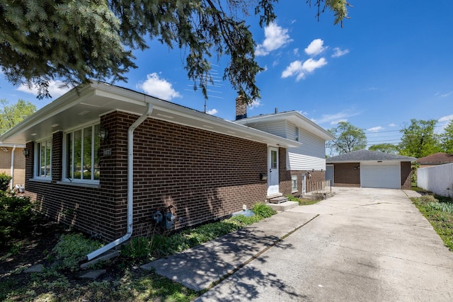 18727 Sherman St, Lansing, IL 60438 - view of side of home with brick siding, an outbuilding, a chimney, driveway, and a detached garage