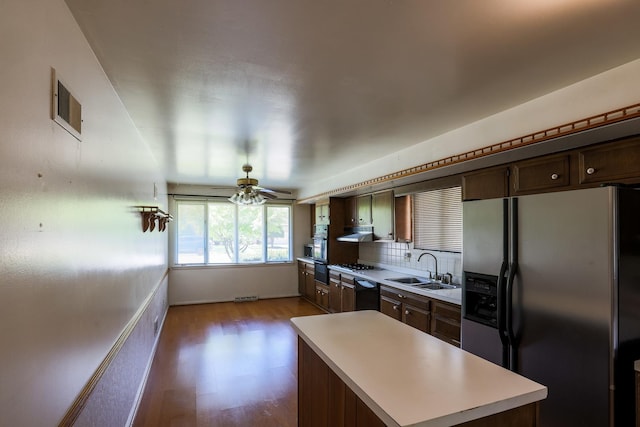 18727 Sherman St, Lansing, IL 60438 - kitchen with appliances with stainless steel finishes, a sink, light countertops, wood finished floors, and ceiling fan