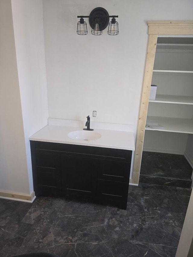 bathroom featuring baseboards and vanity