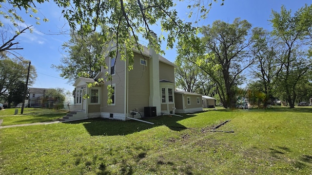 140 E Walnut St, Sheldon, IL 60966 - view of side of property with a yard and central AC unit