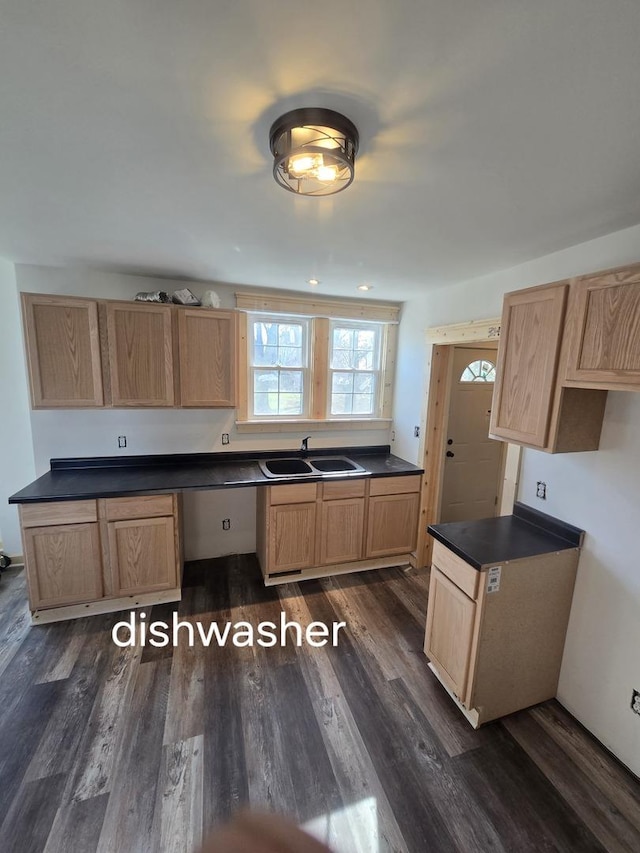 kitchen featuring a sink, dark countertops, dark wood-style flooring, and light brown cabinets