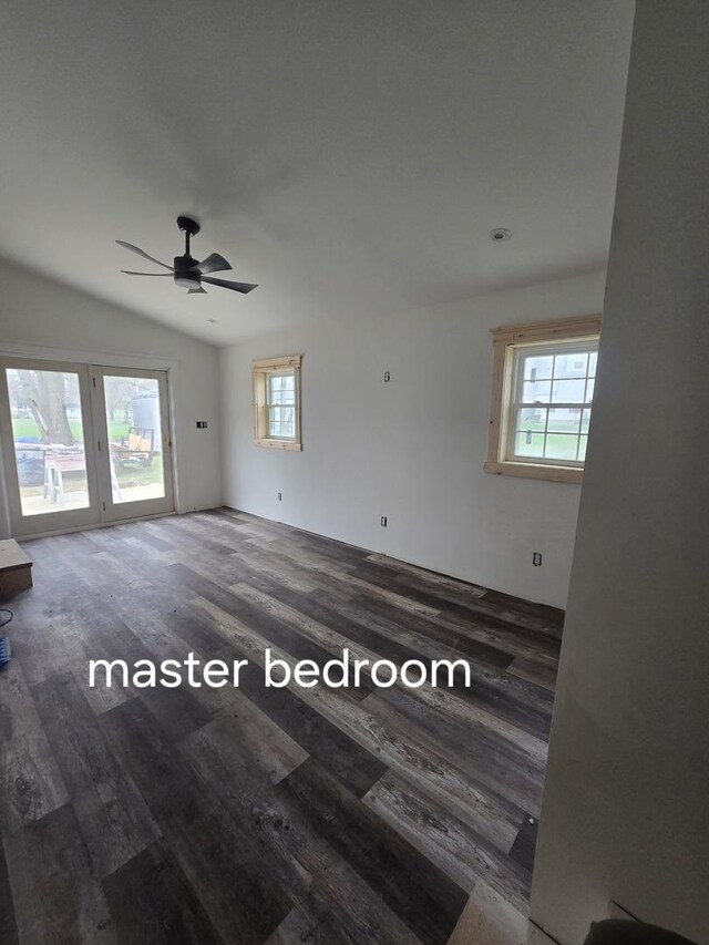 unfurnished room featuring wood finished floors, plenty of natural light, ceiling fan, and vaulted ceiling