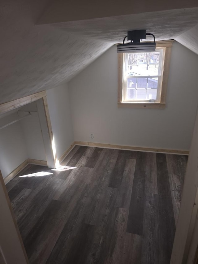 bonus room featuring vaulted ceiling, wood finished floors, and baseboards