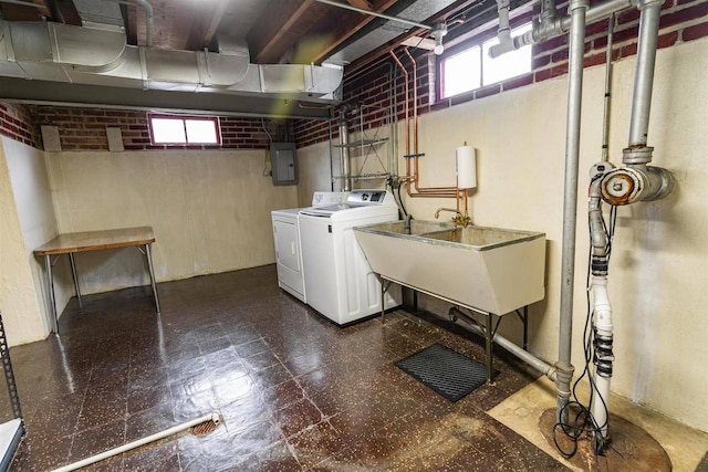 clothes washing area with plenty of natural light, washer and clothes dryer, dark flooring, and electric panel