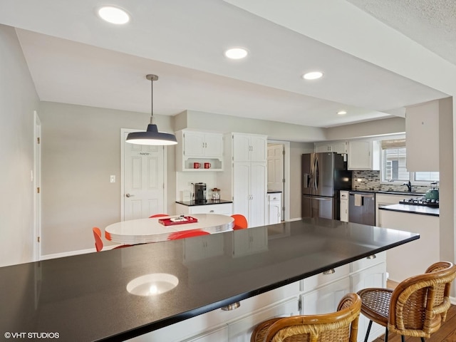 720 Ruskin Dr, Elk Grove Village, IL 60007 - kitchen with appliances with stainless steel finishes, dark countertops, white cabinetry, tasteful backsplash, and recessed lighting