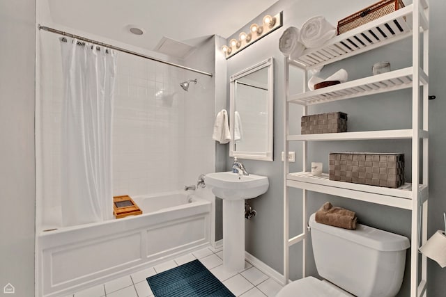 full bath featuring tile patterned flooring, toilet, shower / tub combo, and baseboards