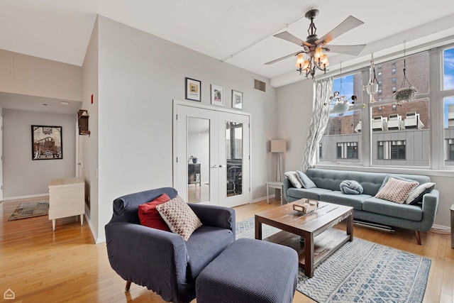 living room featuring french doors, ceiling fan, plenty of natural light, and light wood-style flooring