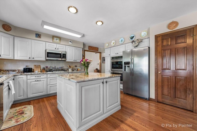 1211 Prairie Dr, Algonquin, IL 60102 - kitchen with appliances with stainless steel finishes, a center island, decorative backsplash, and white cabinets