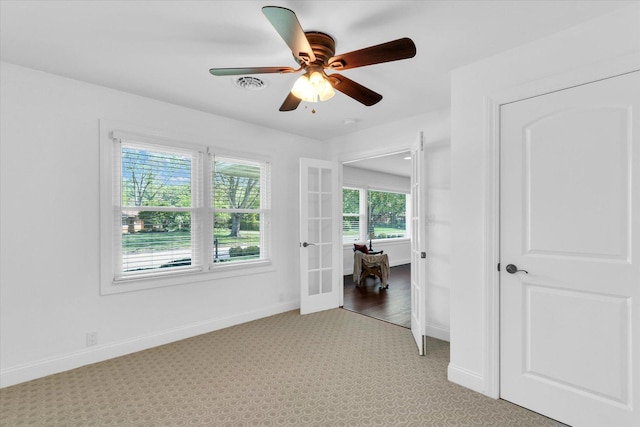 811 Hamilton Dr, Champaign, IL 61820 - spare room with ceiling fan, baseboards, french doors, and light carpet