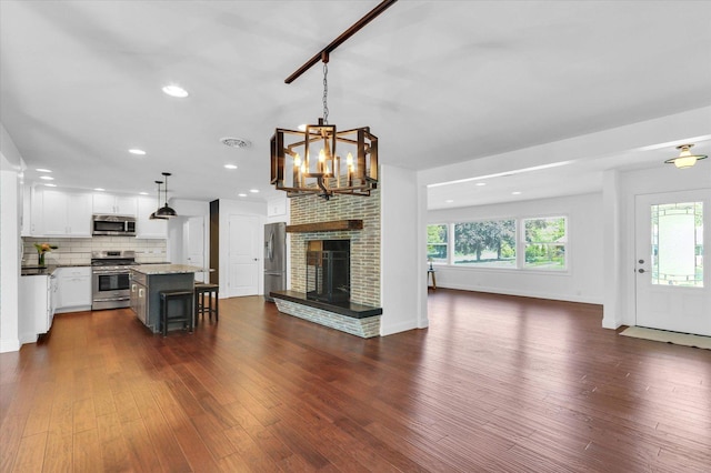811 Hamilton Dr, Champaign, IL 61820 - kitchen with stainless steel appliances, open floor plan, white cabinets, dark wood-style flooring, and recessed lighting