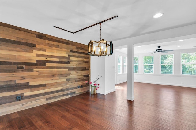 811 Hamilton Dr, Champaign, IL 61820 - unfurnished dining area featuring a chandelier, dark wood-style floors, baseboards, wooden walls, and recessed lighting