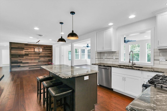 811 Hamilton Dr, Champaign, IL 61820 - kitchen featuring dishwasher, a sink, ceiling fan, a center island, and dark stone countertops