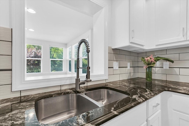 811 Hamilton Dr, Champaign, IL 61820 - kitchen featuring a sink, white cabinets, decorative backsplash, and dark stone countertops
