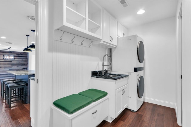 811 Hamilton Dr, Champaign, IL 61820 - laundry area featuring stacked washer and clothes dryer, dark wood-type flooring, baseboards, and recessed lighting