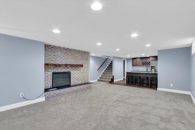 811 Hamilton Dr, Champaign, IL 61820 - unfurnished living room featuring carpet flooring, wet bar, baseboards, and recessed lighting