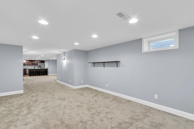 811 Hamilton Dr, Champaign, IL 61820 - below grade area with stainless steel refrigerator with ice dispenser, recessed lighting, light carpet, and baseboards